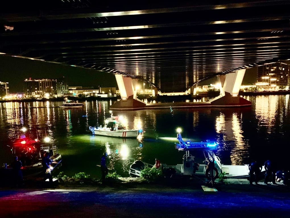 Authorities perform search and rescue efforts after a vehicle went into the Anacostia River under the Frederick Douglass Memorial Bridge on Thursday night.