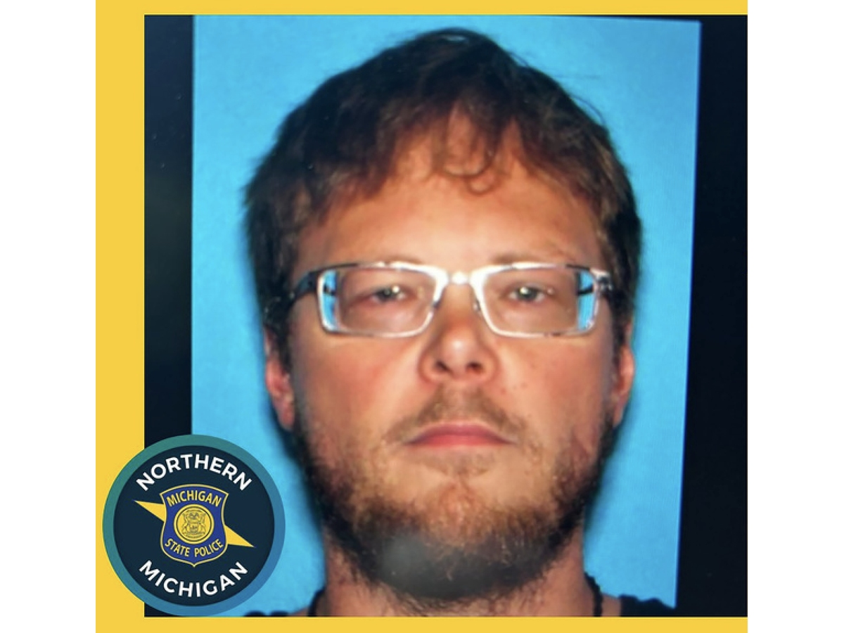 This undated poster provided by the Michigan State Police - Seventh District shows Chad Hickman, who was the suspect in the killing of 5 people and was found dead on Friday.