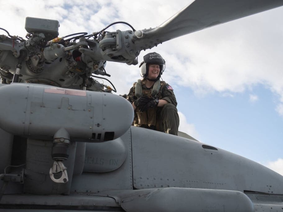 U.S. Navy pilot Katie Gallagher performs pre-flight maintenance.