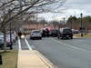 Police set up a perimeter behind the Bel Air Plaza shopping center.