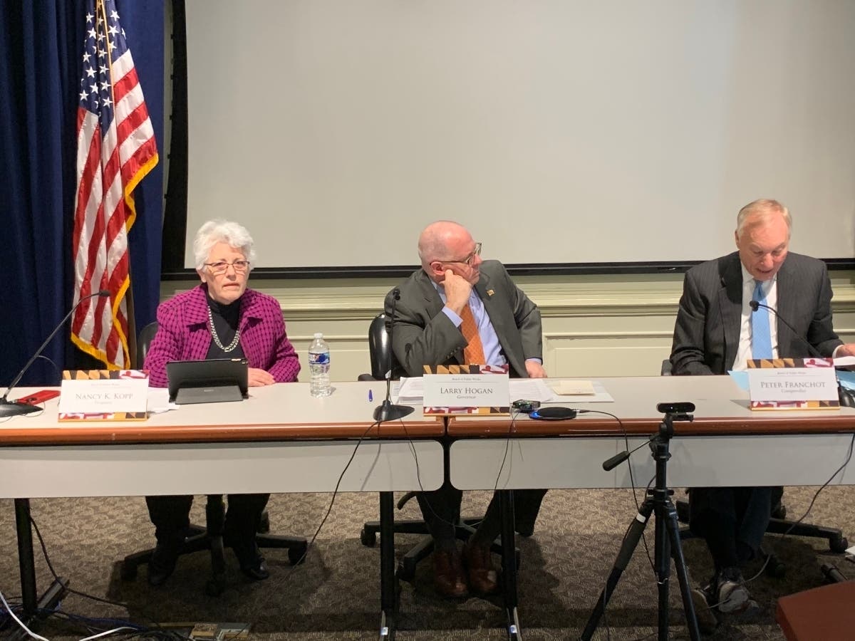 Treasurer Nancy Kopp, Gov. Larry Hogan, center, and Comptroller Peter Franchot approved $2.9 million each in compensation for three men wrongfully imprisoned more than 30 years ago in a middle-school killing over a Georgetown jacket.