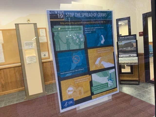A CDC sign at a Harford County government building offers tips such as  "Avoid close contact with people who are sick" and "Wash your hands often with soap and water for at least 20 seconds."