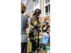 Firefighter Robbie Perry provides oxygen to a dog using a pet oxygen mask after the pet inhaled smoke Sunday, March 15.