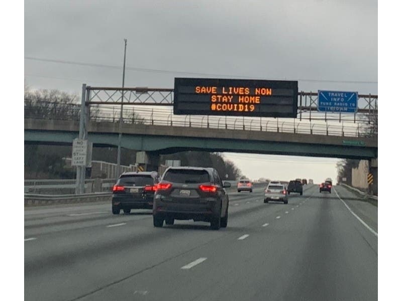 Highway signs on Interstate 95 in Maryland say: "Save Lives Now. Stay Home. #COVID19"