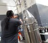  White Tiger Distillery owner Itsara Ounnarath extracts ethanol to produce hand sanitizer.