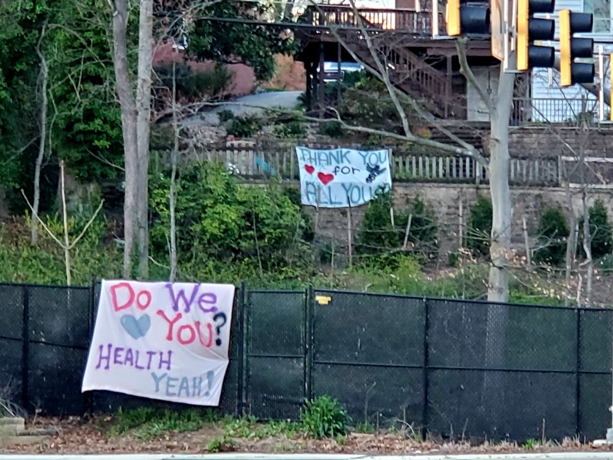A sign up on Towsontown Boulevard at Osler Drive celebrates the contributions of health care workers.