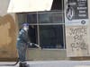 Workers were pressure-washing graffiti from buildings along East Fayette Street Sunday, May 31.