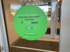 A sign at the entryway to the shopping center says face coverings are rquired.