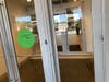 A sign at the entryway to the shopping center says face coverings are rquired.