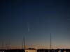 The comet appears to rise tail first, followed by its bright head.