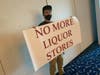 Several protesters held signs on one side of the room at Waters Edge in Belcamp, where the liquor board hearing was held Wednesday, Aug. 26.