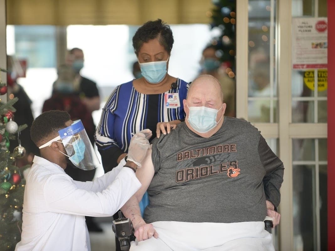 Samuel Cushing, 70, received the coronavirus vaccine at Franklin Woods Center Wednesday, Dec. 23. He is accompanied by Donna Jones, director of nursing, who was among the first staff members to be vaccinated.