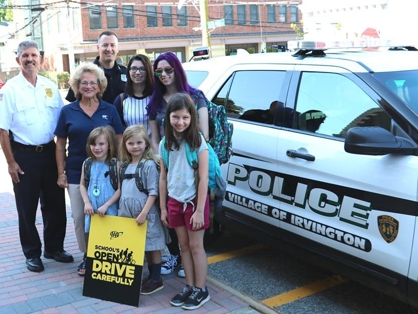 Chief Michael Cerone, (left), Donna Galasso, AAA’s Assistant Director of Traffic Safety, and Police Officer Matt Eckert launched AAA’s 74th annual “School’s Open – Drive Carefully” campaign at the Irvington Police Department.