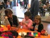 These children are busy with their bead creations at the bead-making station in the firehouse during the third annual Community Day at the Golden's Bridge Fire Department.