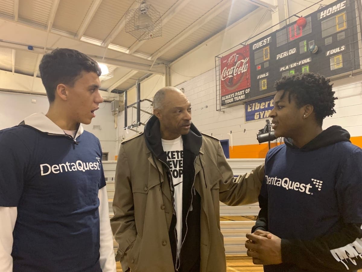 Jim Cleamons talks with basketball team members at an event in the Boys and Girls Club of New Rochelle, Remington Unit.