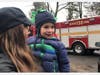 5-year-old Bruno Palermo getting a lift from mom Danielle for a better view of the fire trucks of the Golden's Bridge Fire Department during the surprise birthday drive-by.