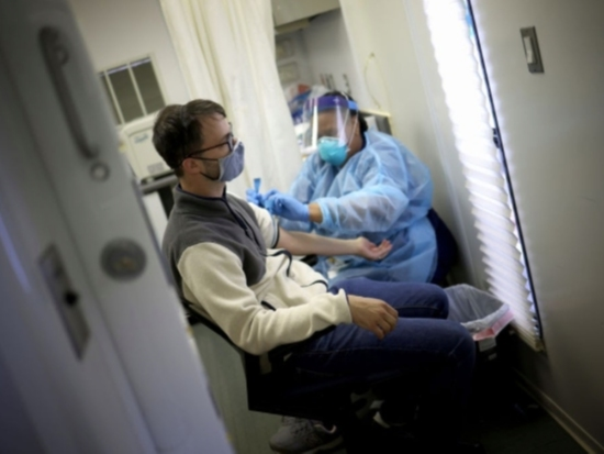 A man has his blood drawn for an antibody test for the coronavirus, also called a serology test. A new report says a record 5.4 million Americans have lost health insurance amid the coronavirus pandemic.