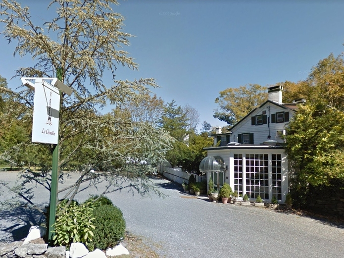 The former owner of an upscale restaurant was sentenced to prison for fraud.