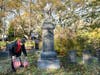 Robert Del Vecchio placing a flag on the grave of George Munson at the Sleepy Hollow Cemetery.