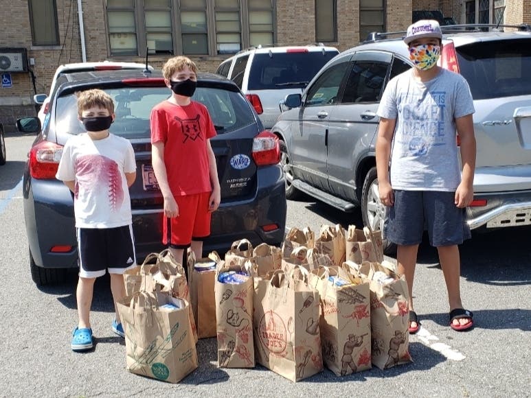 A group of Camp Vollo youth with food donations they collected to support the critical local food insecurity crisis that reached record highs during the pandemic.