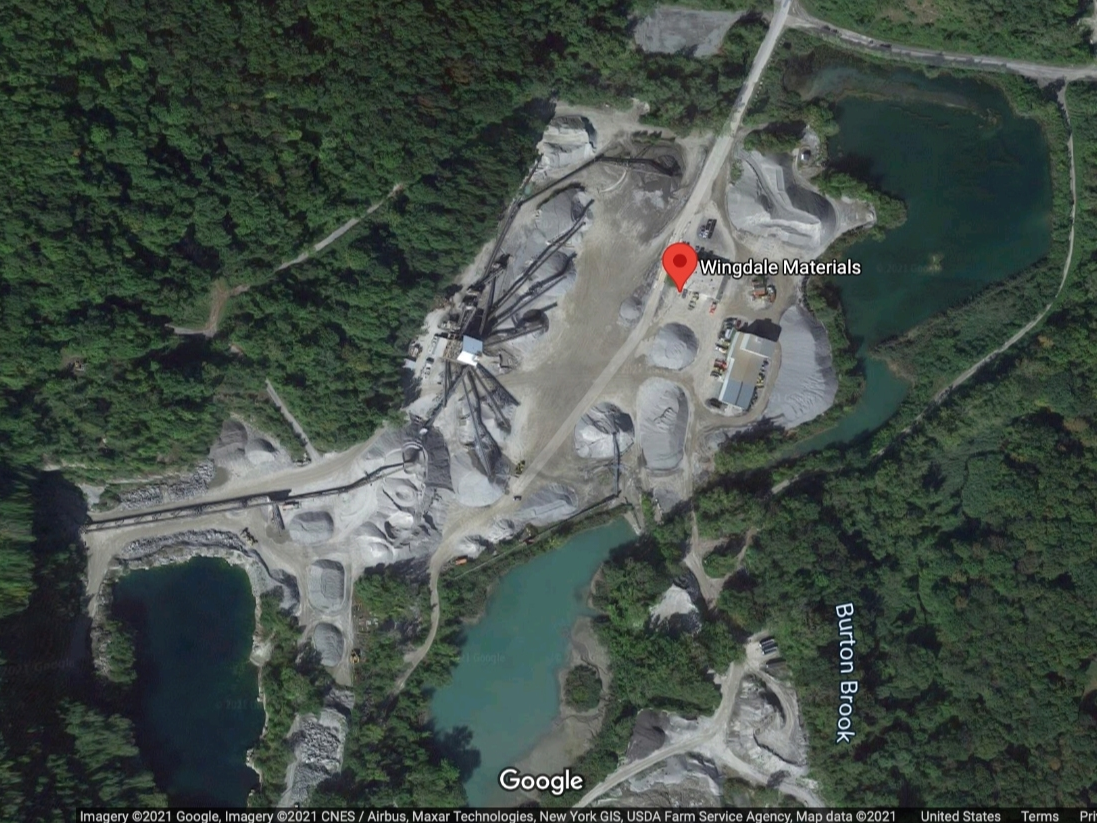 A worker at a mining company was rescued Tuesday after a boulder landed on his excavator.