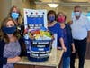 Michelle DePaolis (left), Twila Roos, Debbie Cole, Linda Sorrels and Frank Toland gather at the LincolnWay Community Bank Mokena branch to take a gift basket to the Mokena police department.