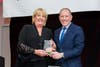 Cindy Ullrich (l), co-owner of Reds Garden Center, accepts the Business of the Year Award from Harley Korman.