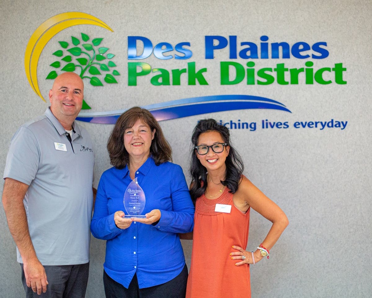 Des Plaines Park District Executive Director Don Miletic, Donna Adam and Park Board President Erin Doerr with the Community Honor Roll Award presented by the Des Plaines Park District at the August 17, 2022 Park Board meeting.