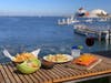 Oceanfront setting and flanked by fresh, crisp tortilla chips and homemade salsa from left to right is Shrimp Mercado Cevihce, Taco Trio and Barbacoa Quesadilla.