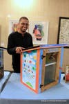 Artist Aston LeMelle-Thomas with his design when the Pop-Up Libraries were presented at City Hall in October, 2018.