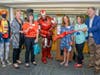 Iron Man cuts the ribbon with (L to R) NRPLF Board member Aline Misner Halle, NRPLF President Chris Selin, NRPL Trustee Whitney Barrat, NY State Assembly Member Amy Paulin, NRPLF Vice President Lynn Green and Library Director Tom Geoffino