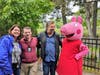New Rochelle Public Library staff members Lisa Itzkowitz, Robert Simic and Director Tom Geoffino cozy up with a costumed character at the birthday bash.
