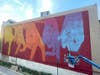 Artist Case Maclaim at work on the wall on Centre Avenue.