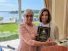 NRCCS President Karenann Carty presents a Community Champion award to Lynn Moloshok Green