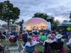 As dusk falls the lights come up on the Hudson Park bandshell.
