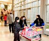 D30 Superintendent Dr. Brian Wegley follows a student and Student Council Co-sponsors Lynn Reimer and Iris Zhang to help them pack the toys into six cars awaiting transport to Youth Services headquarters. 