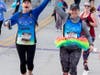 Katherine McCleary (left) of South Elgin and Mary Kate Ternberg celebrate as they prepare to cross the finish line of the 2019 Healthy Driven Naperville 5K on Oct. 20.