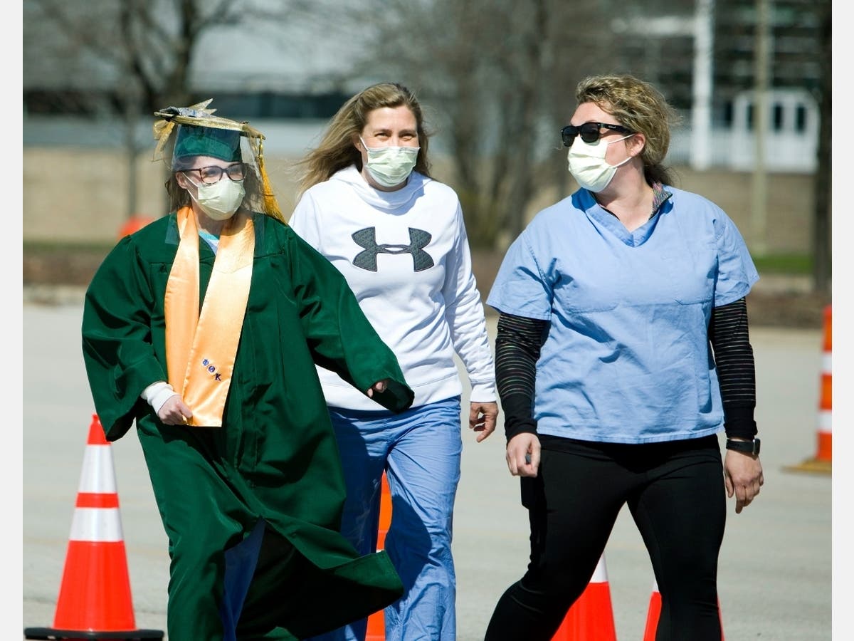 (from left) Amelia Barone is escorted to her surprise college graduation ceremony by co-workers Michelle Vermeland and Margaret Wright. 