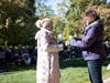 Natalie Valentin of Plainfield (left) and Megan Hofbauer of Darien, members of the Walk Committee, exchange white roses at SHARE’s 16th Annual “A Walk to Remember” Oct. 15.
