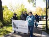 Event Chair Rachel Helfrich Tobin of Bolingbrook (right) carries the banner to lead the 2022 “A Walk to Remember” with (left to right) Kristen Knight Tobin and Jonathon Tobin of Naperville and Nicholas Tobin of Bolingbrook.