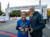 Kathryn Rohr, 12, Naperville, with Joe Dant, President, Edward Hospital & South Institutes, NorthShore – Edward-Elmhurst Health, was the winner of the female division of the Healthy Driven Naperville 5K on Oct. 16 with a time of 21:04.