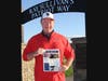 Dan Sanderson, President of The Gridiron Football Club, proudly displays the newly designed Gridiron newsletter at Portsmouth High School’s Ray Sullivan’s Patriot Way.