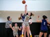 Northwestern University freshman Emma Nelsen skies for the opening tip that began the team's game against the University of Wisconsin-Milwaukee on February 4th. The action came during a tournament hosted by the Wildcats.