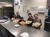 Shown with their completed Purim pastry creations are Club TBA members . 