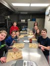 Shown with their completed Purim pastry creations are Club TBA members . 