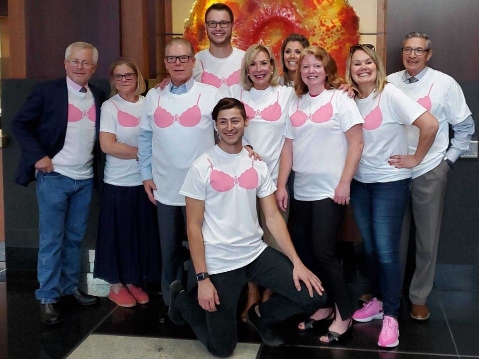 Tim Ross, CEO of Ross Mortgage Corporation, poses with fellow Ross Mortgage employees and friends from the company’s Birmingham, Brighton, Clarkston and Bloomfield Hills branch locations during a fundraiser in honor of Breast Cancer Awareness Month.