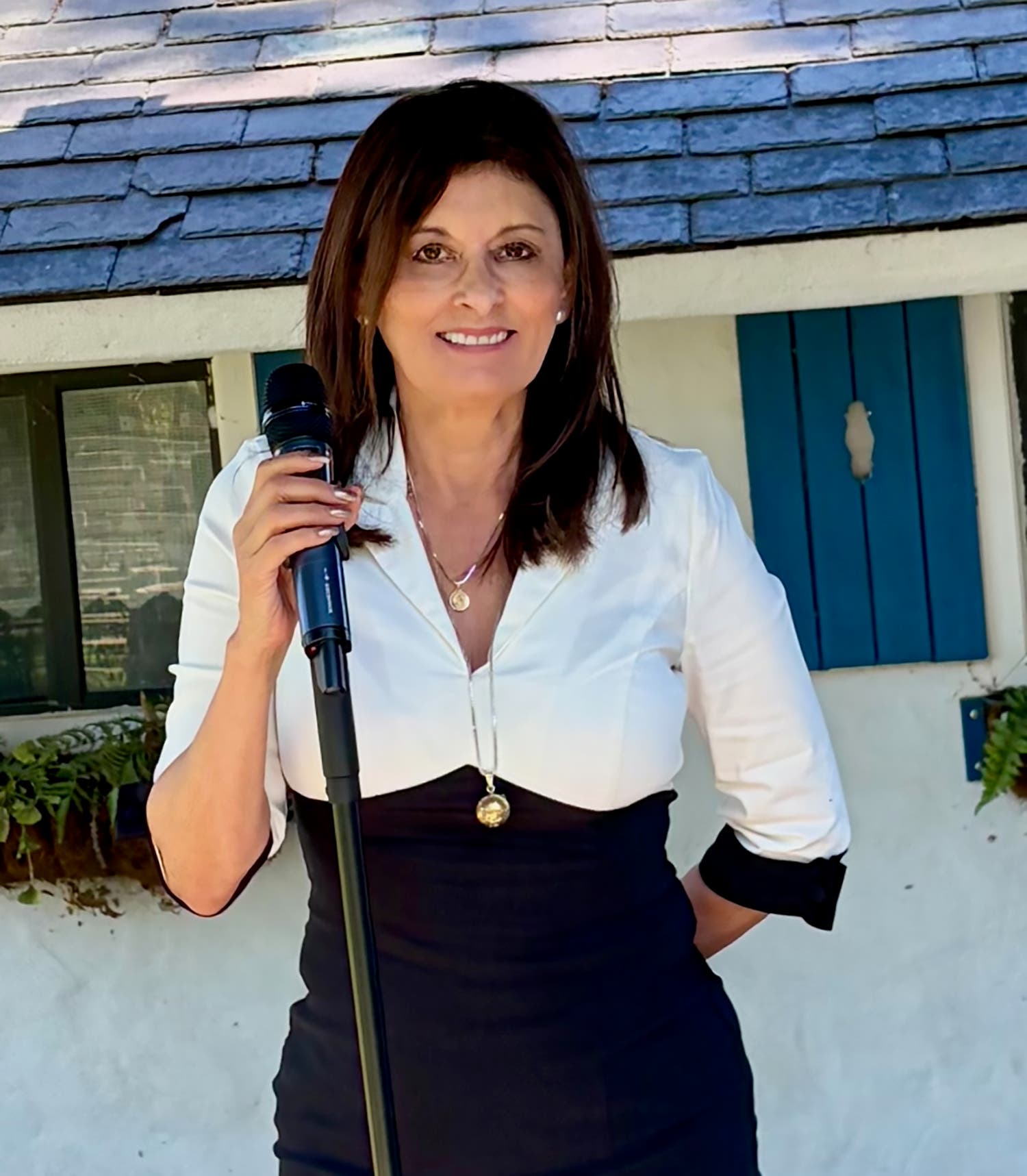 wedding officiant with microphone, black and white dress