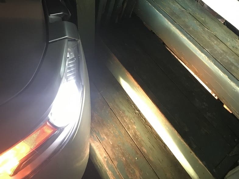 Car veers across lawn and stops at deck