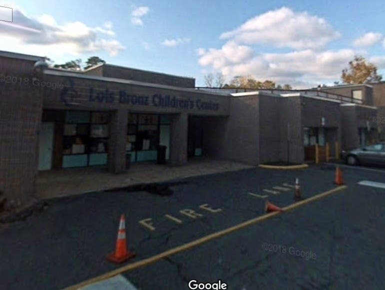 The former executive director of the children's center was charged with grand larceny.