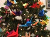 Hundreds of origami “Caring Cranes” decorate two trees at the Field Library in Peekskill, and anyone can take one.
